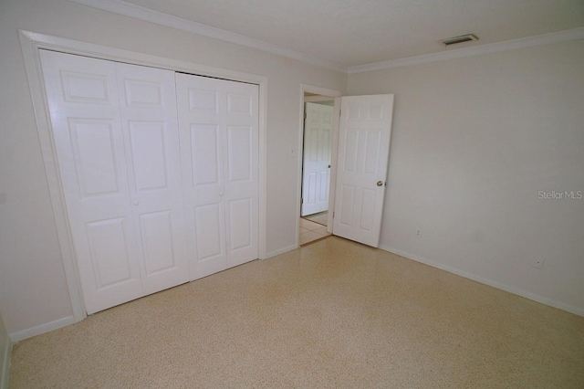 unfurnished bedroom featuring a closet and crown molding