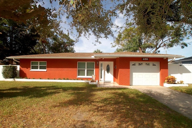 single story home featuring a front yard and a garage