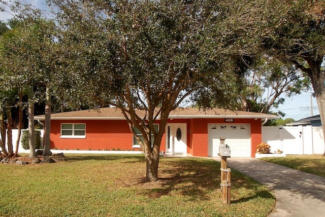 single story home with a garage, driveway, brick siding, and a front lawn