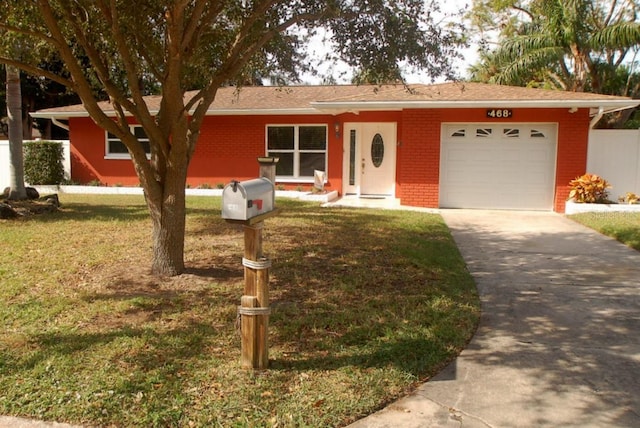 single story home featuring a garage and a front yard