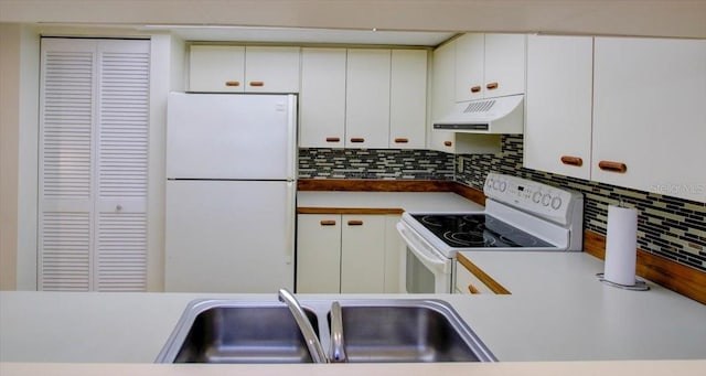 kitchen with sink, white appliances, decorative backsplash, and white cabinets