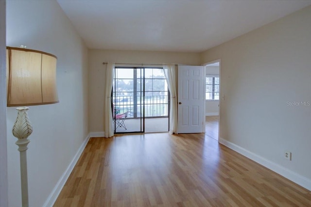 empty room featuring light hardwood / wood-style flooring and a wealth of natural light