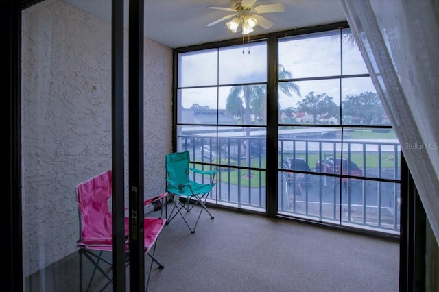 sunroom featuring ceiling fan