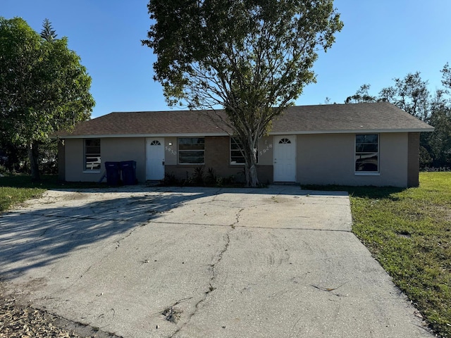 5928 13th Street Ct E, Bradenton, FL 34203 - ranch-style home with a shingled roof, a front lawn, and stucco siding