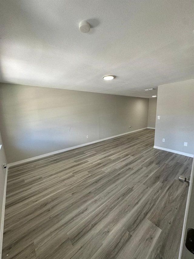 5928 13th Street Ct E, Bradenton, FL 34203 - spare room featuring baseboards, dark wood-style flooring, and a textured ceiling