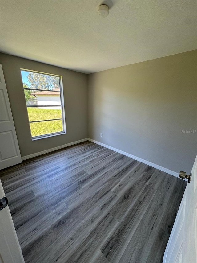 5928 13th Street Ct E, Bradenton, FL 34203 - spare room featuring dark wood finished floors and baseboards