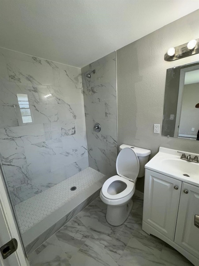 5928 13th Street Ct E, Bradenton, FL 34203 - full bath featuring toilet, tiled shower, marble finish floor, a textured wall, and vanity