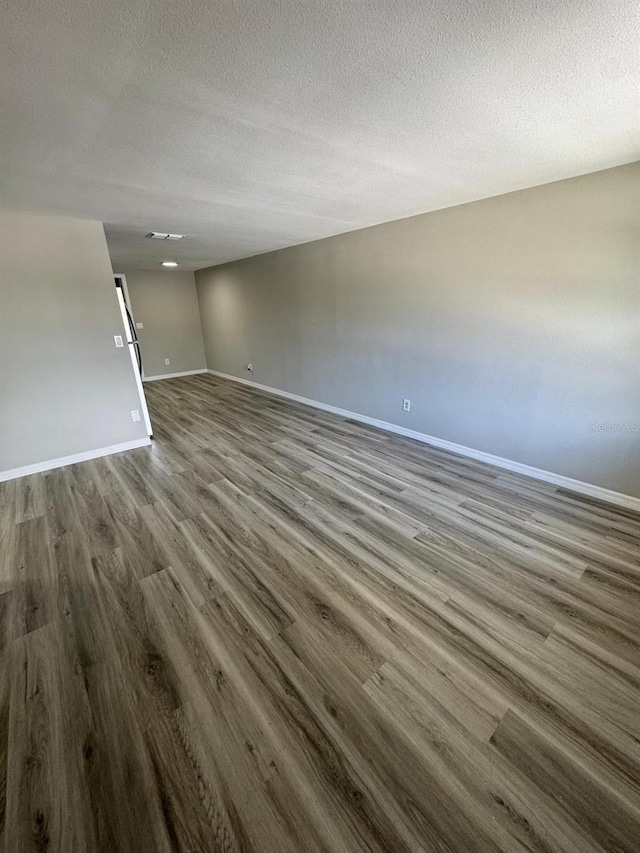 5928 13th Street Ct E, Bradenton, FL 34203 - interior space with visible vents, wood finished floors, baseboards, and a textured ceiling