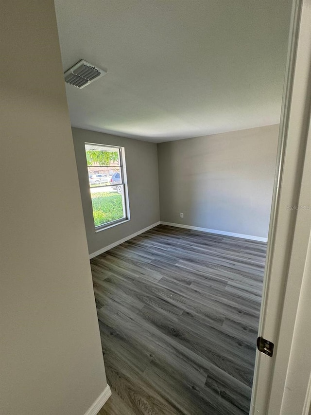 5928 13th Street Ct E, Bradenton, FL 34203 - unfurnished room with baseboards, dark wood-type flooring, and visible vents
