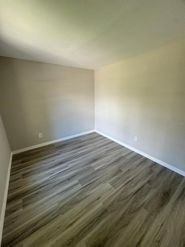 5928 13th Street Ct E, Bradenton, FL 34203 - empty room with baseboards and dark wood-style flooring