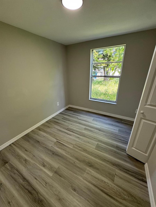 5928 13th Street Ct E, Bradenton, FL 34203 - unfurnished room with wood finished floors and baseboards