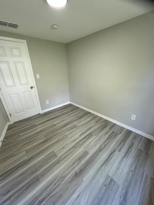 5928 13th Street Ct E, Bradenton, FL 34203 - spare room featuring wood finished floors, visible vents, and baseboards