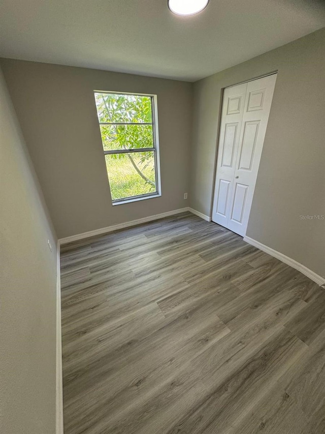 5928 13th Street Ct E, Bradenton, FL 34203 - spare room featuring wood finished floors and baseboards