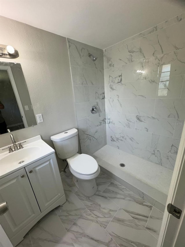 5928 13th Street Ct E, Bradenton, FL 34203 - full bathroom with toilet, tiled shower, marble finish floor, a textured wall, and vanity