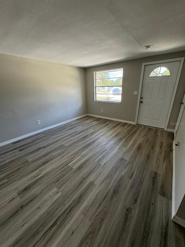 5928 13th Street Ct E, Bradenton, FL 34203 - foyer featuring wood finished floors, a textured ceiling, and baseboards