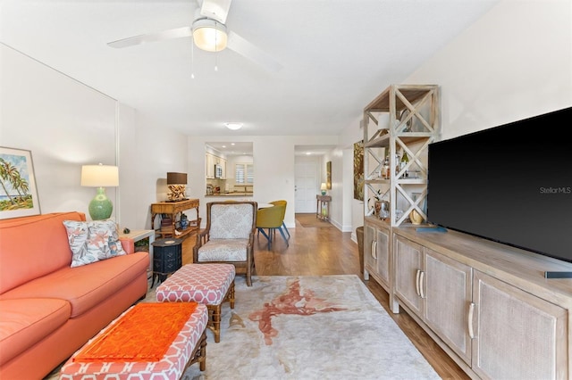 living room with light wood-type flooring and ceiling fan