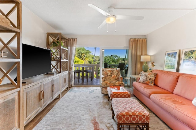 living room with light wood-type flooring and ceiling fan