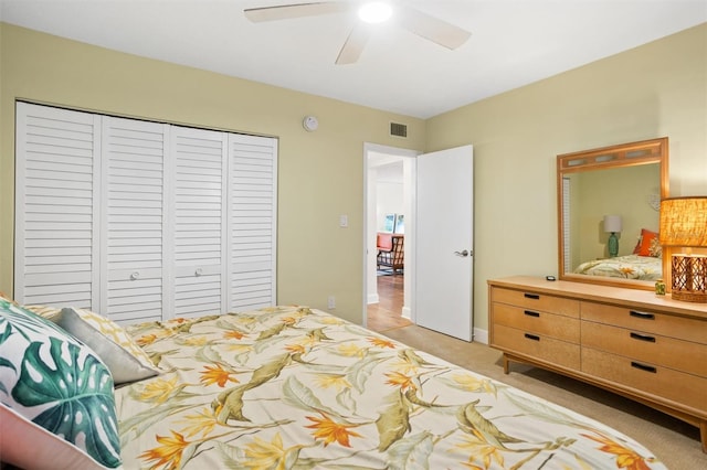 carpeted bedroom with a closet and ceiling fan