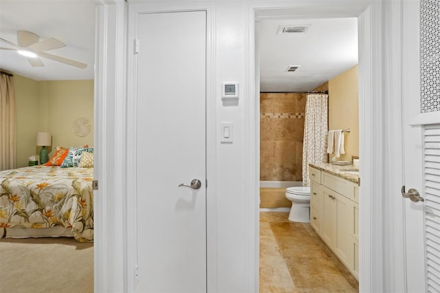 bathroom with vanity, a shower with shower curtain, toilet, and ceiling fan