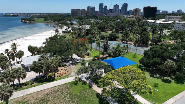 birds eye view of property featuring a water view and a beach view