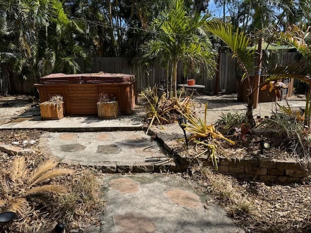 view of yard featuring a patio and a hot tub