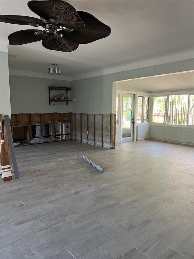 unfurnished living room featuring ceiling fan