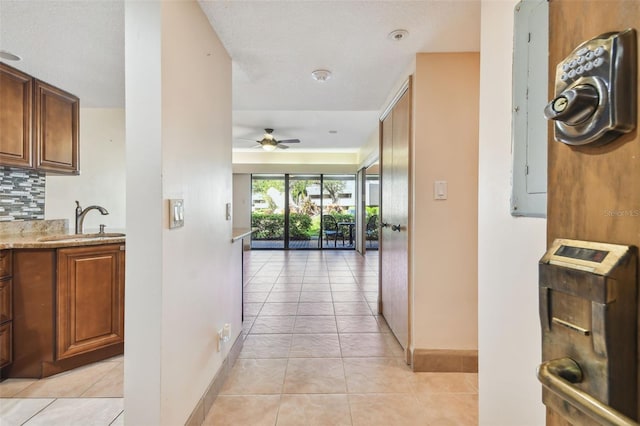 36750 US Highway 19 N Unit 19106, Palm Harbor, FL 34684 - corridor with a sink, baseboards, light tile patterned flooring, and electric panel