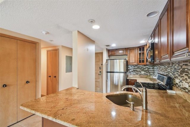 36750 US Highway 19 N Unit 19106, Palm Harbor, FL 34684 - kitchen with stainless steel appliances, a sink, light stone countertops, electric panel, and decorative backsplash