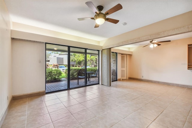 spare room with light tile patterned flooring and ceiling fan