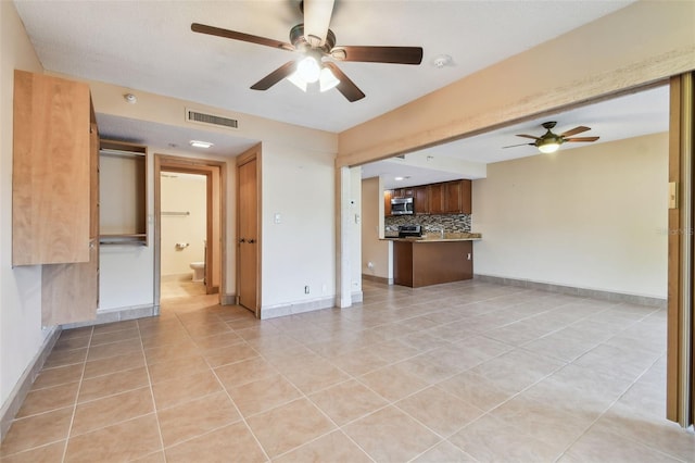 36750 US Highway 19 N Unit 19106, Palm Harbor, FL 34684 - unfurnished living room with a ceiling fan, light tile patterned floors, and baseboards