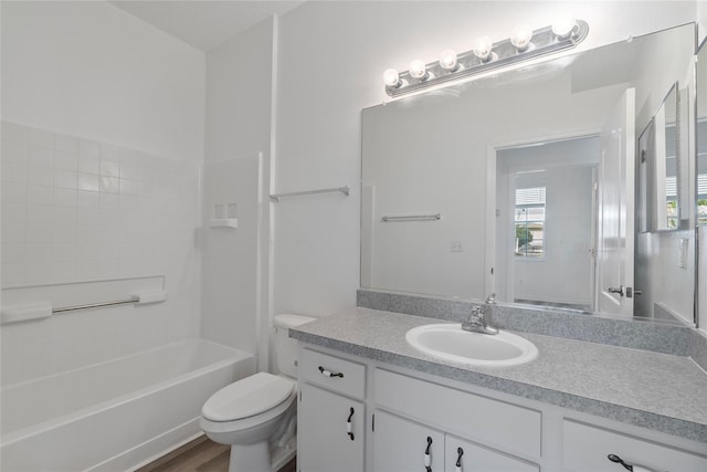 full bath featuring toilet, shower / bath combination, wood finished floors, and vanity