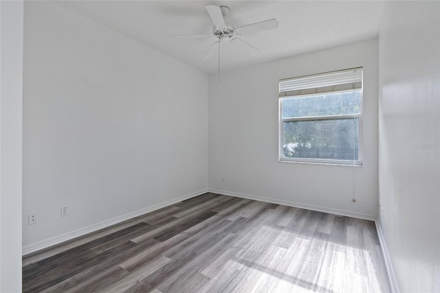 empty room featuring ceiling fan, a textured ceiling, baseboards, and wood finished floors