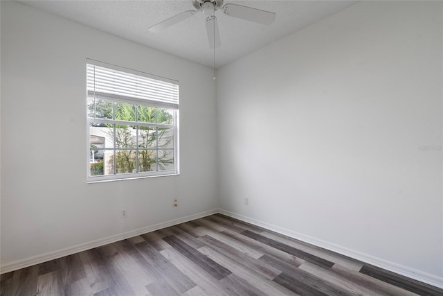 empty room featuring ceiling fan, a textured ceiling, baseboards, and wood finished floors