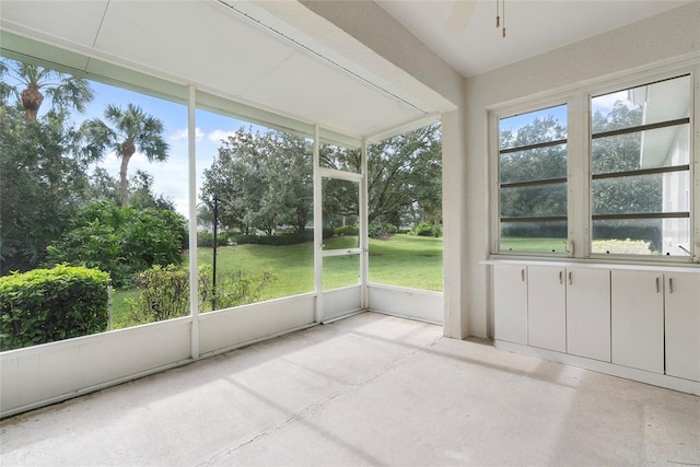 unfurnished sunroom featuring a ceiling fan