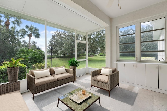 sunroom / solarium featuring a ceiling fan and plenty of natural light