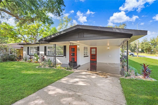 view of front of house with a front lawn and a carport