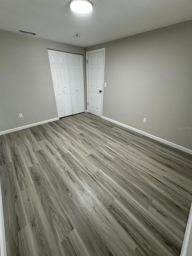 unfurnished bedroom with a closet and light hardwood / wood-style flooring