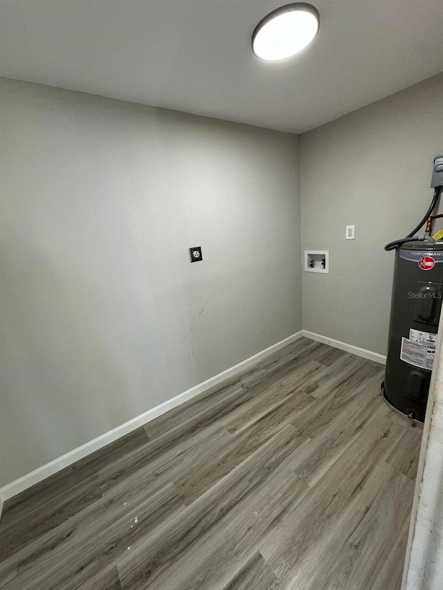 laundry room with dark wood-type flooring, water heater, and hookup for a washing machine