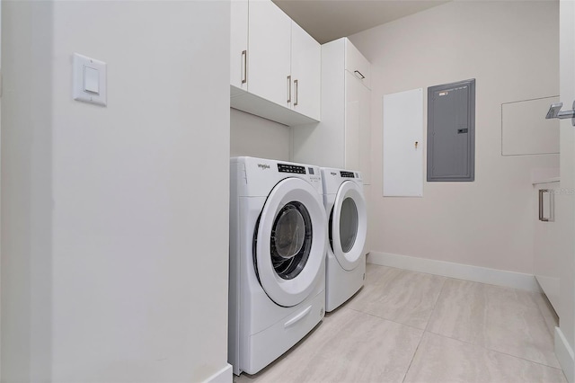 washroom with electric panel, light tile patterned floors, cabinets, and washing machine and dryer