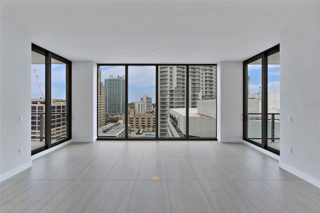 tiled empty room featuring expansive windows