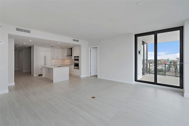 unfurnished living room with sink