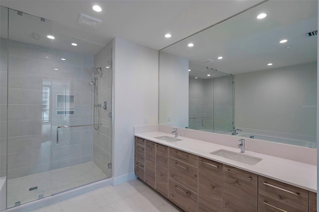 bathroom featuring tile patterned flooring, vanity, and a shower with door