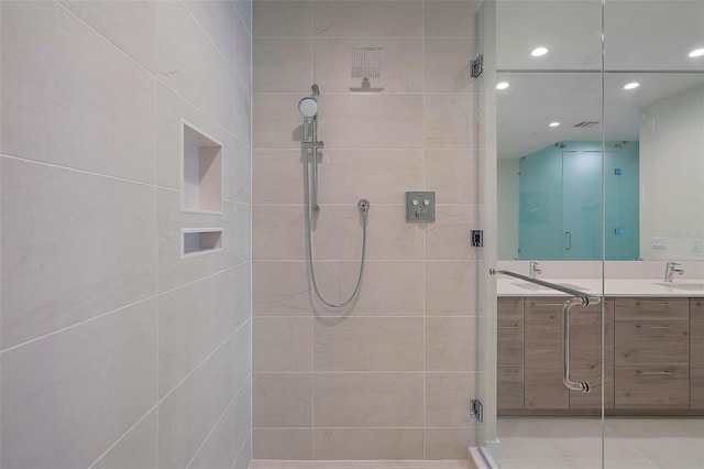 bathroom with tile patterned flooring, vanity, and an enclosed shower