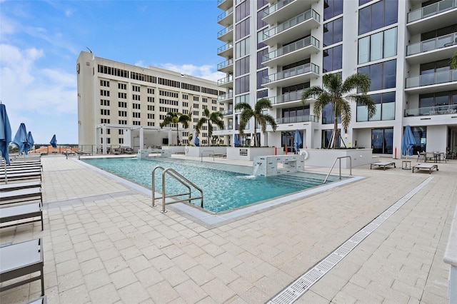 view of pool with pool water feature and a patio