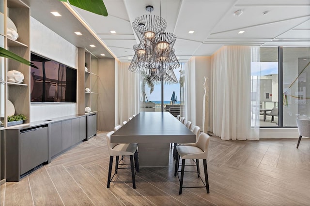 dining room featuring light parquet floors and a notable chandelier