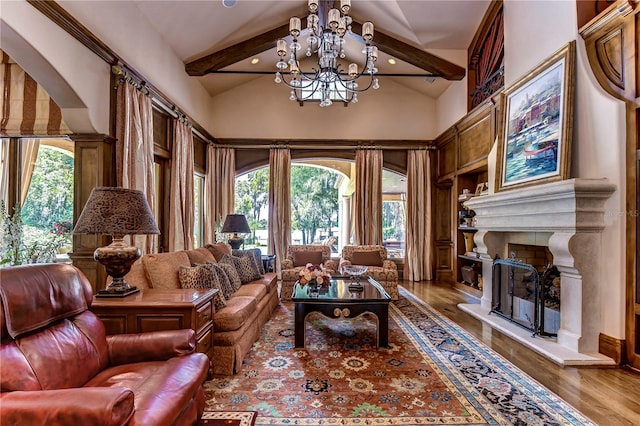 living area with a chandelier, lofted ceiling with beams, and wood-type flooring