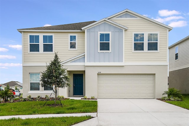 view of front of property with a garage and a front lawn