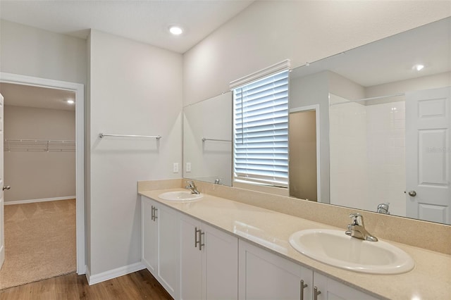 bathroom with vanity, hardwood / wood-style floors, and walk in shower