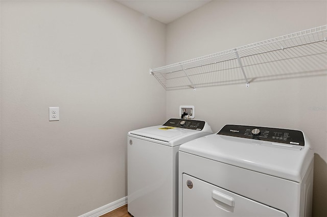 washroom with independent washer and dryer and hardwood / wood-style flooring