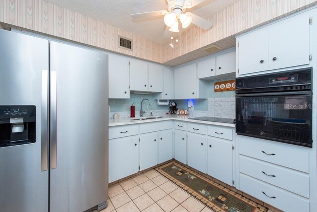 kitchen with white cabinetry, black appliances, and sink